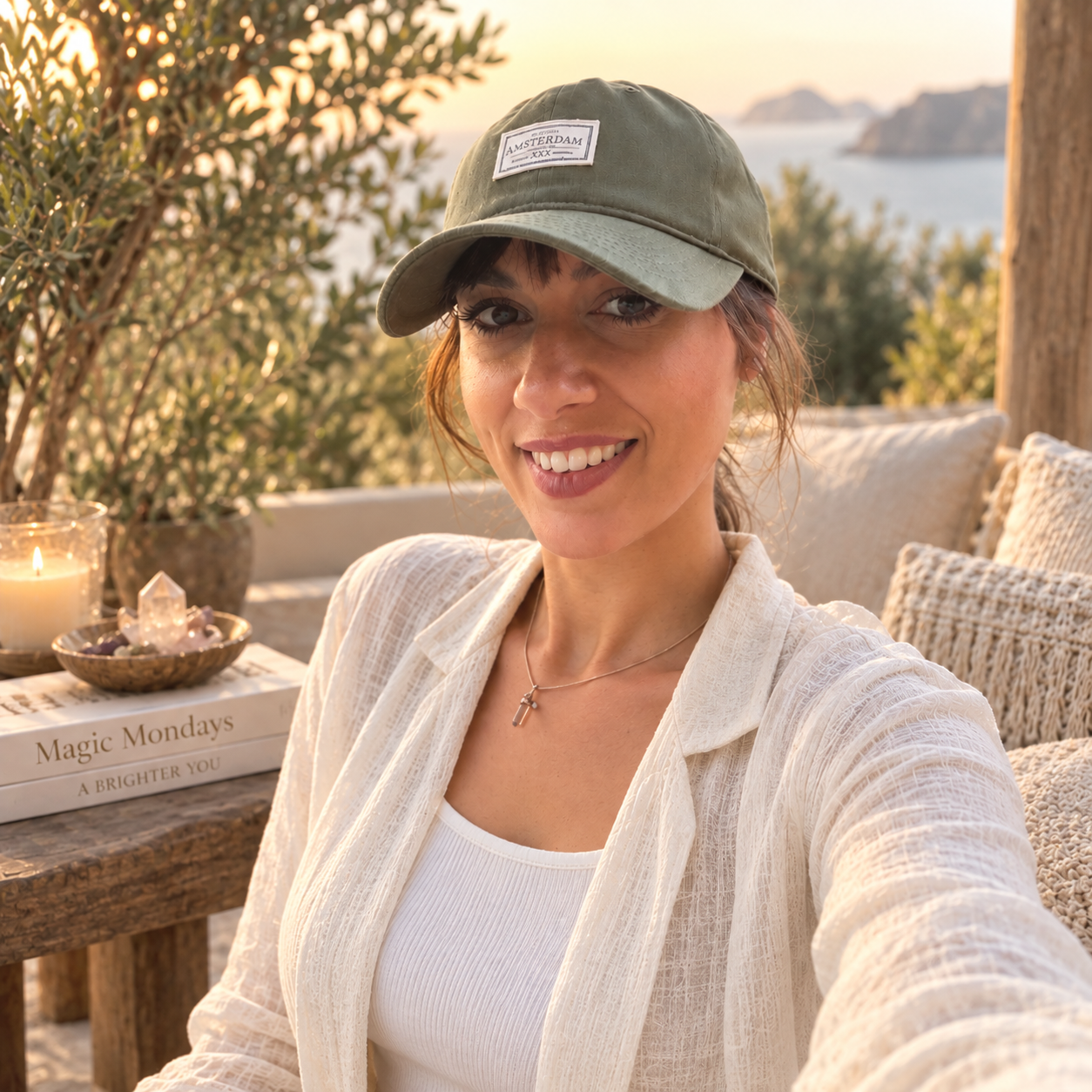 Lea Ivaneta smiling in golden-hour light by the sea